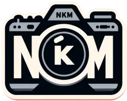 Company logo shaped like a professional camera with the letters NKM written inside it